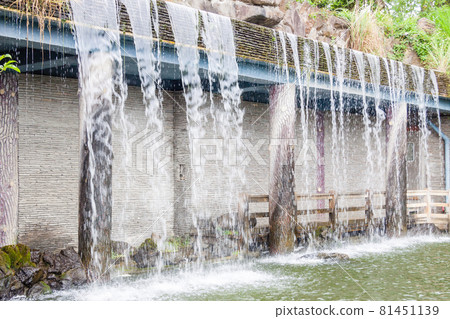 NEW TAIPEI CITY, TAIWAN - JANUARY 27, 2012: Waterfall at Guan Dao Guan Ying Temple NEW TAIPEI CITY, TAIWAN - JANUARY 27, 2012: Waterfall at Guan Dao Guan Ying Temple 81451139