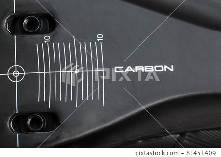 Carbon element of cycling shoes with the inscription CARBON on a black background close-up. 81451409