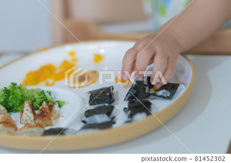 Baby's hand eating rice and grabbing Baby's hand eating rice and grabbing 81452302