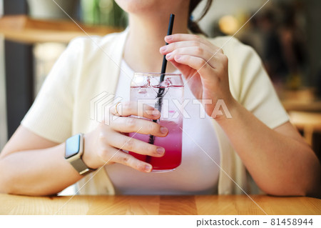 Crop woman enjoying cold drink Crop woman enjoying cold drink 81458944
