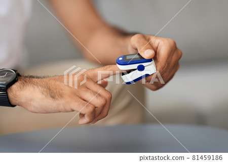 Unrecognizable man using pulse oximeter, closeup photo 81459186