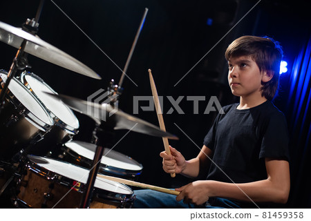 A boy plays drums in a recording studio A boy plays drums in a recording studio 81459358