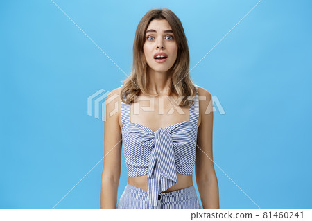 Portrait of silly desperate and upset cute attractive woman with diastema open mouth gasping and frowning from worry and troublesome situation looking with begging eyes at camera over blue wall Portrait of silly desperate and upset cute attractive woman with diastema open mouth gasping and frowning from worry and troublesome situation looking with begging eyes at camera over blue wall 81460241
