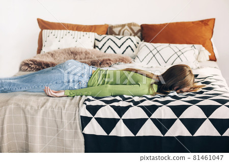 Exhausted young female student or housewife lying on bed face down Exhausted young female student or housewife lying on bed face down 81461047