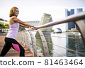 Close-up of attractive happy female athlete stretching 81463464