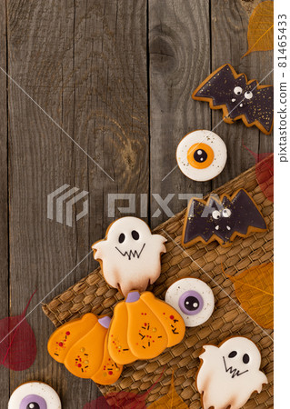 Delicious halloween homemade cookies of various shapes on old wooden table 81465433