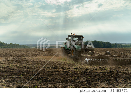 The tractor plows the land. Agriculture image The tractor plows the land. Agriculture image 81465771