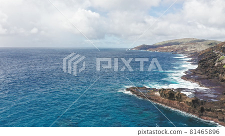 Flying over volcanic cliffs. Cinematic wild nature aerial 4K. Slow motion waves of transparent sea waters. Outdoor adventure travel to beautiful Hawaii beach. Untouched nature on sunny summer day. Flying over volcanic cliffs. Cinematic wild nature aerial 4K. Slow motion waves of transparent sea waters. Outdoor adventure travel to beautiful Hawaii beach. Untouched nature on sunny summer day. 81465896