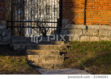 stairs to wicket in mansion's brick fence 81466061