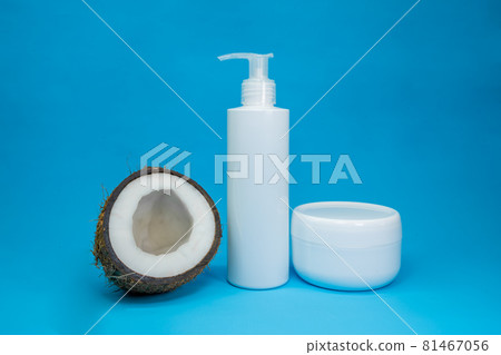 White cosmetic bottle and jar with coconut, cosmetic product on blue background. Minimal concept. Showcase for presentation skincare products White cosmetic bottle and jar with coconut, cosmetic product on blue background. Minimal concept. Showcase for presentation skincare products 81467056
