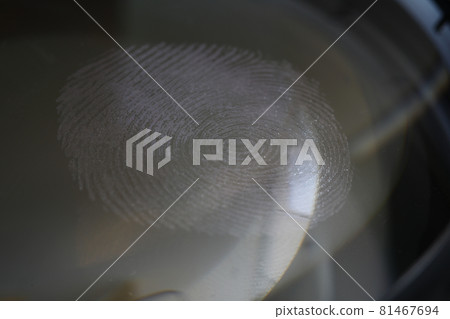 Close-up fingerprint on glass on dark background 81467694