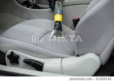 Man car detailing studio worker cleaning car textile upholstery Man car detailing studio worker cleaning car textile upholstery 81468140