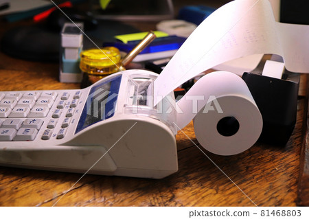 Closeup of the paper roll on a calculator adding machine Closeup of the paper roll on a calculator adding machine 81468803