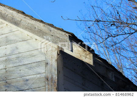 Edge of an Abandoned Farm Shed Against a Blue Sky 81468962