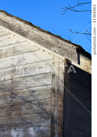 Edge of an Abandoned Farm Shed Against a Blue Sky 81468963