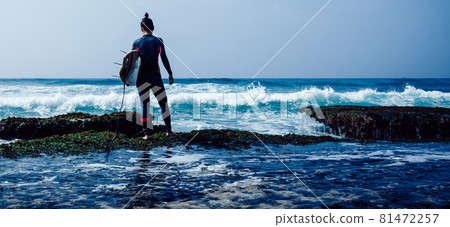 Woman surfer with surfboard going to surf on seaside Woman surfer with surfboard going to surf on seaside 81472257