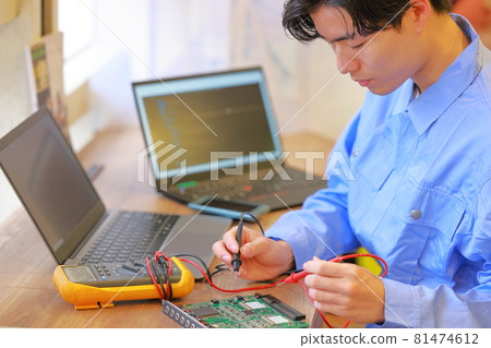 Electrical engineer checking the board with a circuit tester 1 81474612