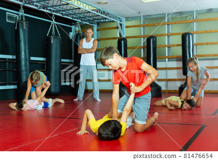Kids in pair exercising self-defense movements Kids in pair exercising self-defense movements 81476654