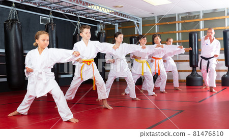 Group of girls and boys in kimono doing kata 81476810