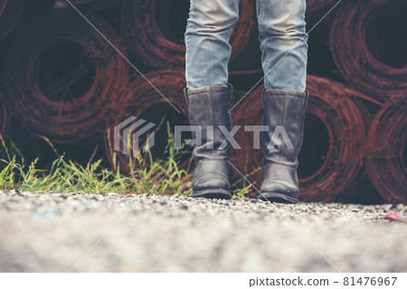 Women wear construction Boots safety footwear for worker at construction site. Woman Engineer Wear Jeans black Boots Worker standing at construction site. Engineer safety industry footwear walking Women wear construction Boots safety footwear for worker at construction site. Woman Engineer Wear Jeans black Boots Worker standing at construction site. Engineer safety industry footwear walking 81476967