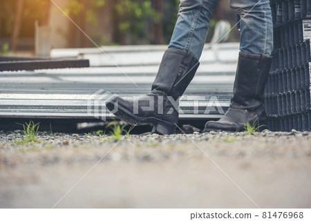 Women wear construction Boots safety footwear for worker at construction site. Woman Engineer Wear Jeans black Boots Worker standing at construction site. Engineer safety industry footwear walking Women wear construction Boots safety footwear for worker at construction site. Woman Engineer Wear Jeans black Boots Worker standing at construction site. Engineer safety industry footwear walking 81476968