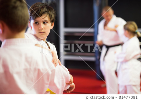 Kids on karate training in gym Kids on karate training in gym 81477081