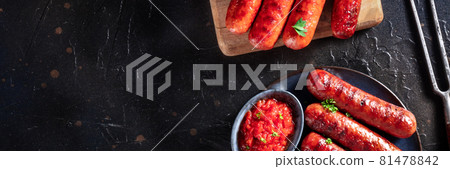 Sausages panoramic banner with a place for text, top shot on black Sausages panoramic banner with a place for text, top shot on black 81478842