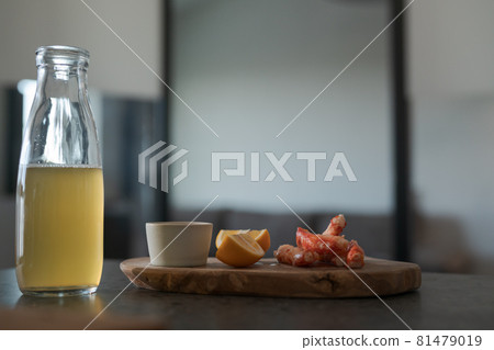 Crab legs with lemon and dressing on olive woob board Crab legs with lemon and dressing on olive woob board 81479019