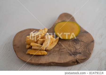 Freeze-dried mango with fresh one on olive wood board with copy space Freeze-dried mango with fresh one on olive wood board with copy space 81479114