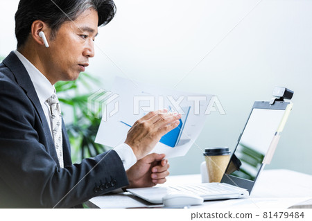 Businessmen attending remote meetings Businessmen attending remote meetings 81479484