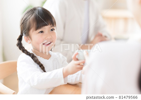 Family meal scene Girl refilling rice Family meal scene Girl refilling rice 81479566
