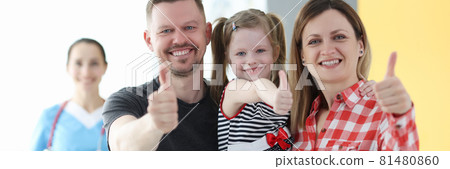 Parents and little girl showing thumbs up at doctor appointment 81480860