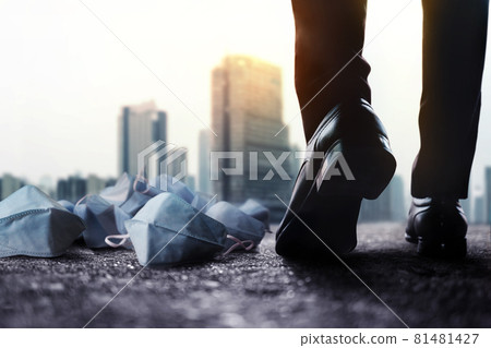 Motivation, Steps Forward into a Successful Concept. Challenging of Business during Coronavirus. Low Section of Businessman Walking forward to Passing Medical Mask on ground 81481427