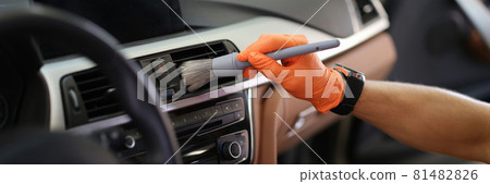 Male hand hold grey blush in orange protective gloves Male hand hold grey blush in orange protective gloves 81482826