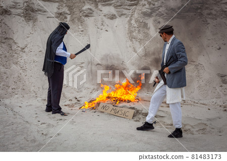 Afghan terrorists destroy music with fire. 81483173