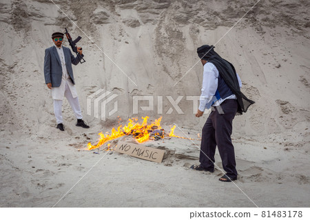Afghan terrorists destroy music with fire. 81483178