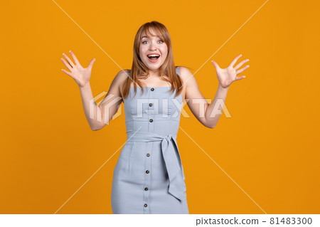 Happy, joyful young beautiful girl isolated on yellow studio background. Concept of human emotions, facial expression, youth, sales, ad. Happy, joyful young beautiful girl isolated on yellow studio background. Concept of human emotions, facial expression, youth, sales, ad. 81483300