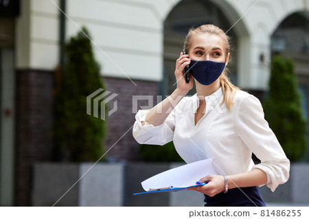 business woman in medical mask talking on phone business woman in medical mask talking on phone 81486255
