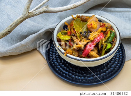Stir fried spicy wild boar with red chili in White bowl. Stir fried spicy wild boar with red chili in White bowl. 81486582