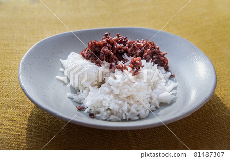 Riceberry and Jasmine rice in white plate. Healthy food and diet concept. Riceberry and Jasmine rice in white plate. Healthy food and diet concept. 81487307