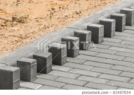 Laying floor tile sidewalk urban road or repairing paving stone slabs at a construction site Laying floor tile sidewalk urban road or repairing paving stone slabs at a construction site 81487654