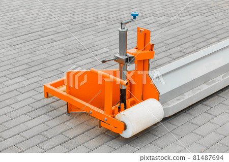 Part of industrial equipment for leveling hard-surfaced surfaces against the background of paving stone tiled slabs. Removes fine sand, grit and various substrates Part of industrial equipment for leveling hard-surfaced surfaces against the background of paving stone tiled slabs. Removes fine sand, grit and various substrates 81487694