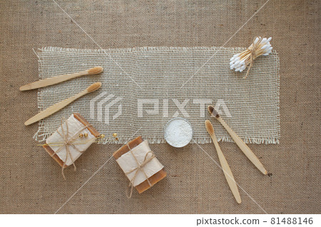 Set of natural bathroom tools, sustainable zero waste and lifestyle concept. Wooden toothbrushes, bamboo swabs, soap, toothpowder on fabric background with copy space, mockup Set of natural bathroom tools, sustainable zero waste and lifestyle concept. Wooden toothbrushes, bamboo swabs, soap, toothpowder on fabric background with copy space, mockup 81488146