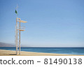 aid station on a beach with calm sea on sunny day and green flag 81490138