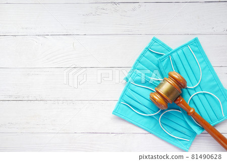 top view of gavel and surgical face mask on table  81490628