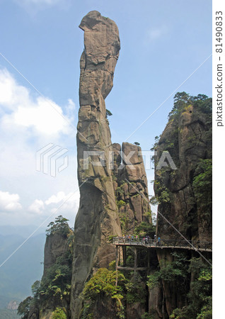 Sanqingshan Mountain in Jiangxi Province, China. View of Snake Rock or Python Rock, a pinnacle on Mount Sanqing, with path and tourists. Sanqingshan is a Taoist mountain famous for its rocky peaks. 81490833