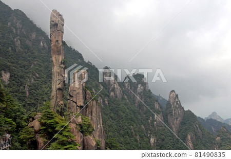 Sanqingshan Mountain in Jiangxi Province, China. View of Snake Rock or Python Rock, a rocky pinnacle on Mount Sanqing. Sanqingshan is a sacred Taoist mountain famous for its misty peaks and forests. Sanqingshan Mountain in Jiangxi Province, China. View of Snake Rock or Python Rock, a rocky pinnacle on Mount Sanqing. Sanqingshan is a sacred Taoist mountain famous for its misty peaks and forests. 81490835