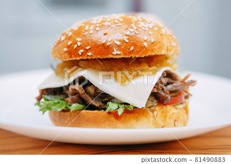 Burgers with beef and vegetables. Delicious burgers in a cooking class. Burger with onion sauce. Burgers with beef and vegetables. Delicious burgers in a cooking class. Burger with onion sauce. 81490883