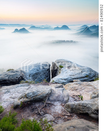 Wake up of misty sandstone mountains with the gradation of creamy clouds Wake up of misty sandstone mountains with the gradation of creamy clouds 81490932