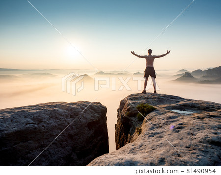 Happy trail runner at rocky view edge raised arms to sun greeting. Happy trail runner at rocky view edge raised arms to sun greeting. 81490954